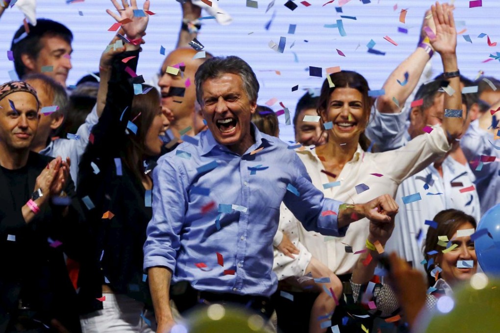 Mauricio Macri, presidential candidate of the Cambiemos (Let's Change) coalition, celebrates with his wife Juliana Awada (behind, in white) after the presidential election in Buenos Aires, Argentina. Photo: Reuters