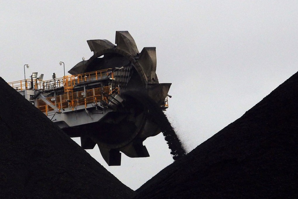 A reclaimer places coal in stockpiles at the coal port in Newcastle in the Australian state of New South Wales. Photo: Reuters