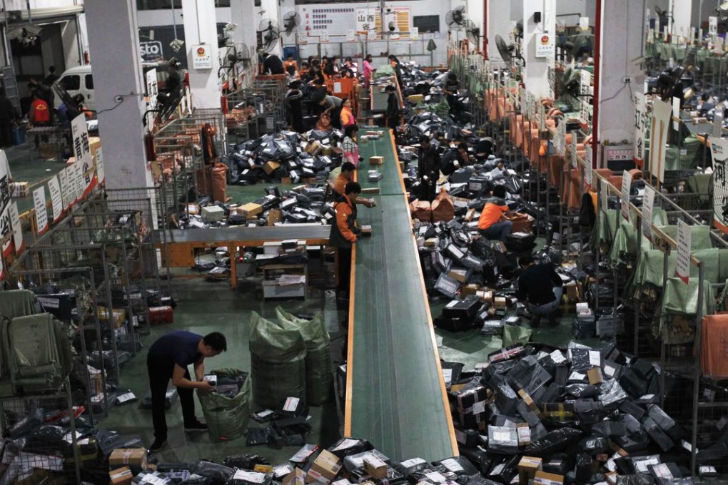 Staff at STO Express sort out packages in Wenzhou, Zhejiang province. The rising popularity of e-commerce on the mainland has improved the efficiency of local businesses and cut costs for consumers. Photo: Xinhua