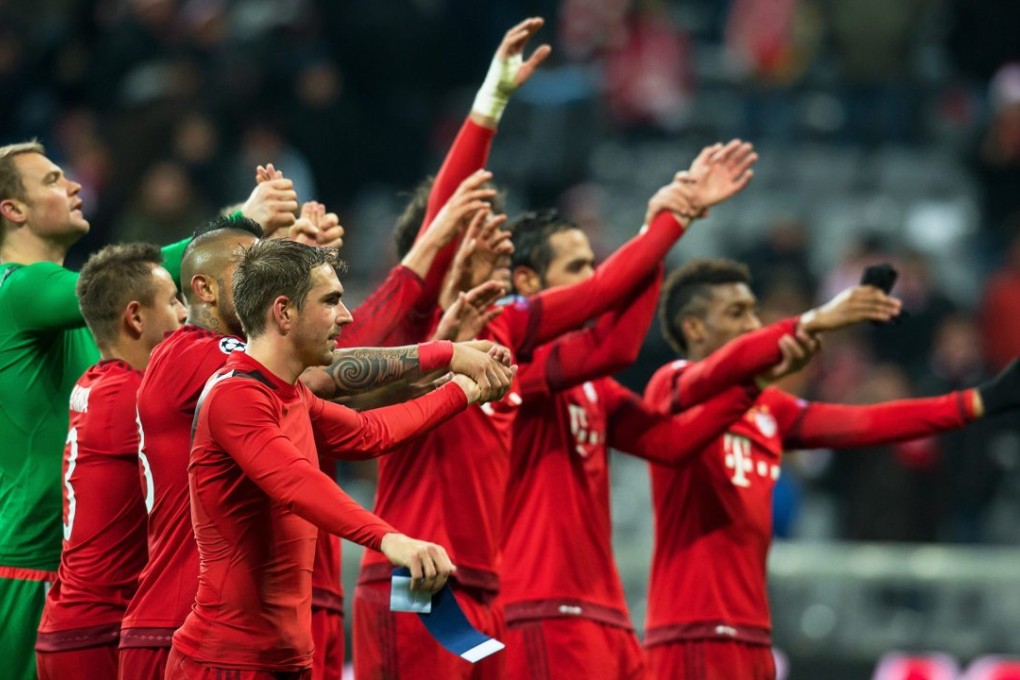 Bayern Munich's captain Philipp Lahm (front) and his teammates celebrate the win. Photo: AFP
