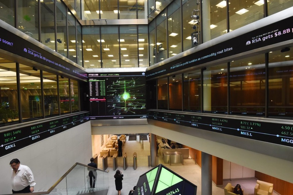 Share prices are seen on screens at the London Stock Exchange in London. A feasibility study is in the works on linking the stock exchanges in London and Shanghai. Photo: EPA