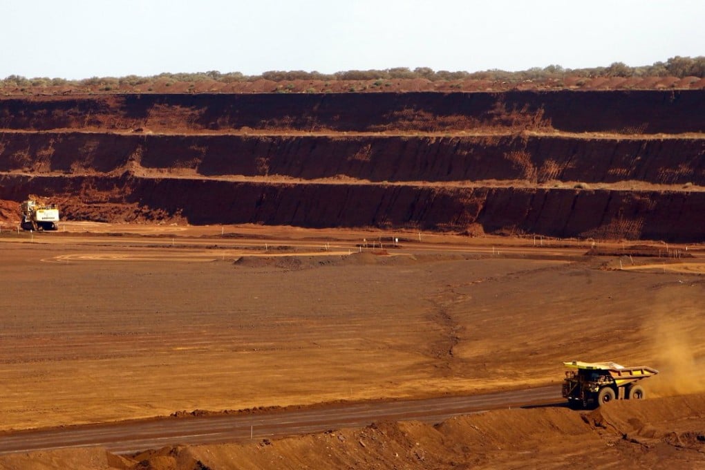 A truck drives along a road to receive a new load of iron ore at Fortescue Metals’ Christmas Creek iron ore mine in the Pilbara region of Western Australia. Photo: Reuters