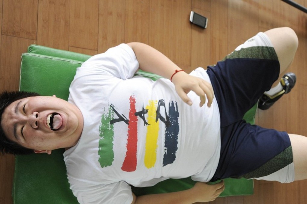 An overweight man trying to shed the pounds at a gym in Beijing. Photo: AFP
