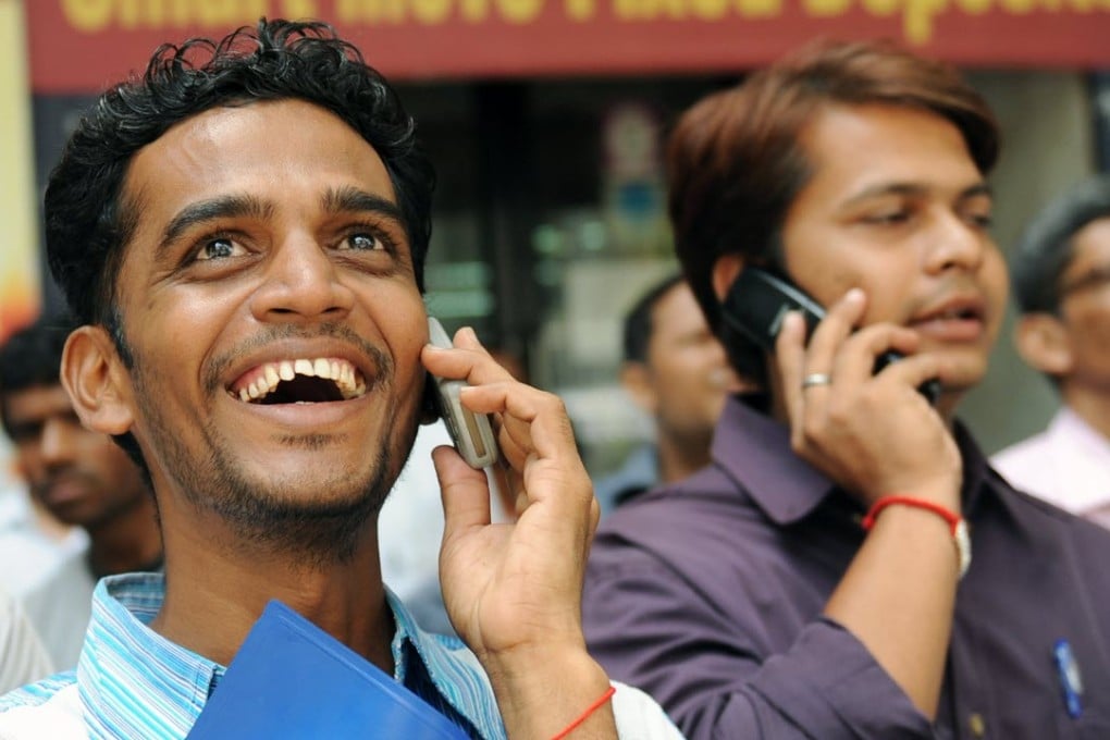 Onlookers watch share prices on a digital stock ticker outside the Bombay Stock Exchange (BSE) building in Mumbai. Photo: AFP