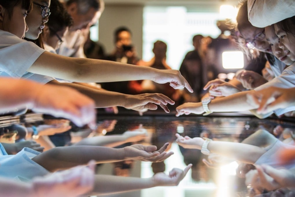 Visiting schoolchildren use an interactive media panel at the newly opened National Gallery Singapore. Photo: Bloomberg