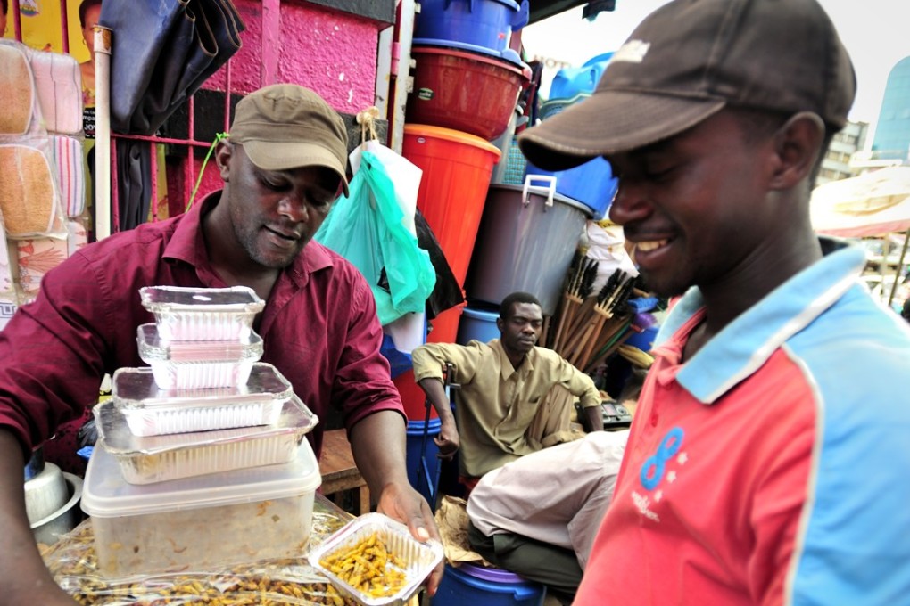 Selling grasshoppers for food in Uganda where the insect is considered a delicacy. © Yannick Tylle/Corbis