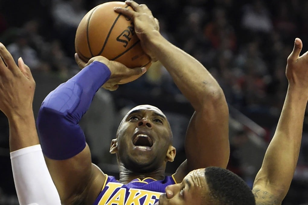 Los Angeles Lakers forward Kobe Bryant (24) shoots the ball over Portland Trail Blazers guard Damian Lillard (0) during the first half of an NBA basketball game on Saturday, Nov. 28, 2015, in Portland, Ore. (AP Photo/Steve Dykes)