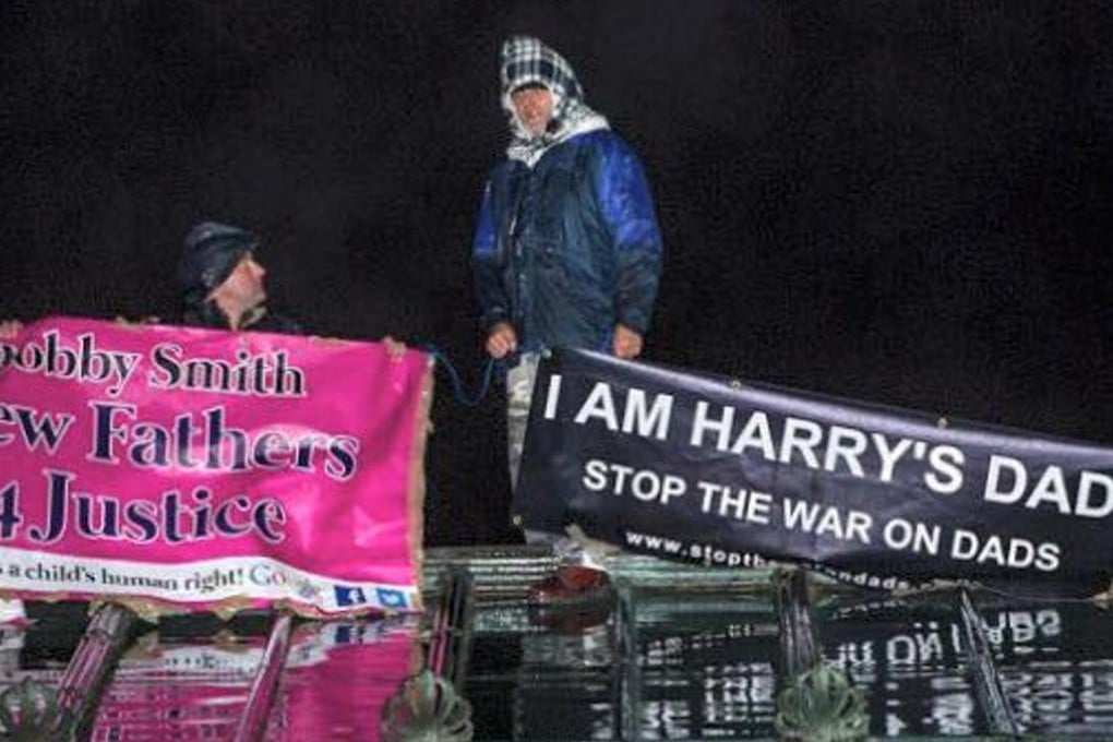 A photo posted on Facebook by the “Fathers Justice” group shows two protesters on top of a Buckingham Palace gallery roof on Sunday night. Photo: Facebook