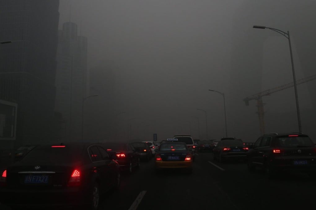 Vehicles travel through a main thoroughfare during a hazy day in Beijing on Tuesday. Photo: EPA