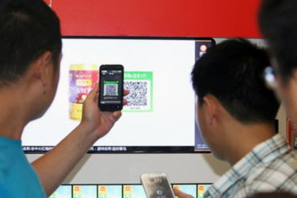 Consumers in Beijing use WeChat to make a purchase at a vending machine in this file photo. Chinese tourists will soon be able to skip at least some currency exchange fees while on holiday by buying goods at foreign stores using WeChat Wallet. Photo: SCMP Pictures
