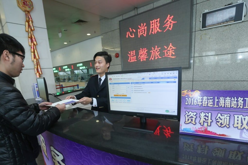 An enterprise representative receives materials about group tickets at the ticket office of Shanghai South Railway Station in Shanghai on November 26. Photo: Xinhua