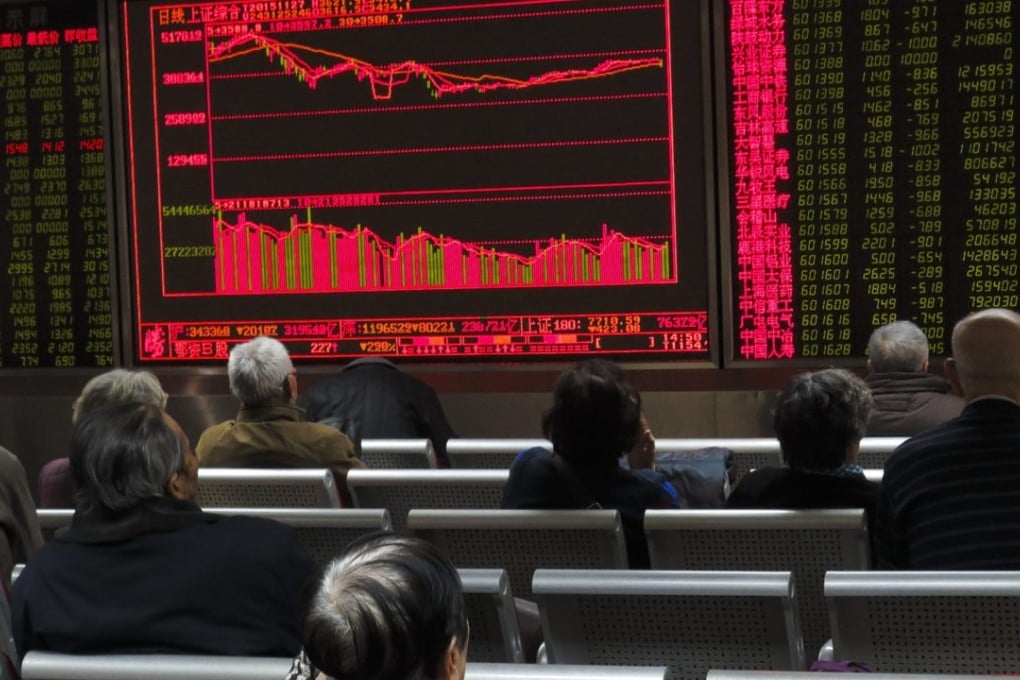 Chinese investors monitor share prices in China’s volatile stock markets. Photo: EPA