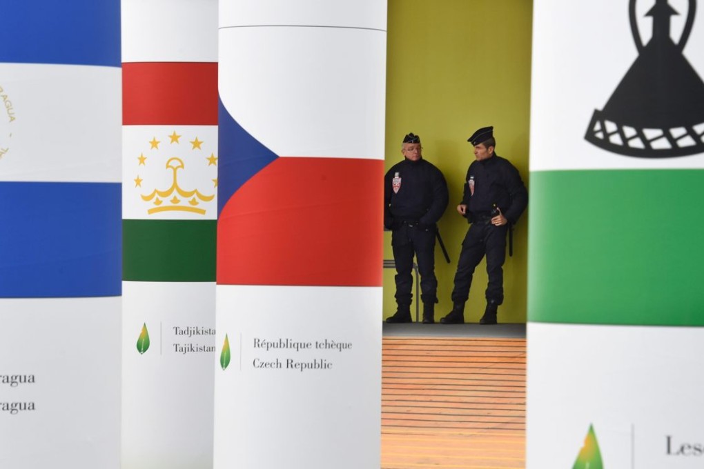 Police officers stand guard at the entrance of the COP21 United Nations Conference on climate change in Paris. Photo: AFP