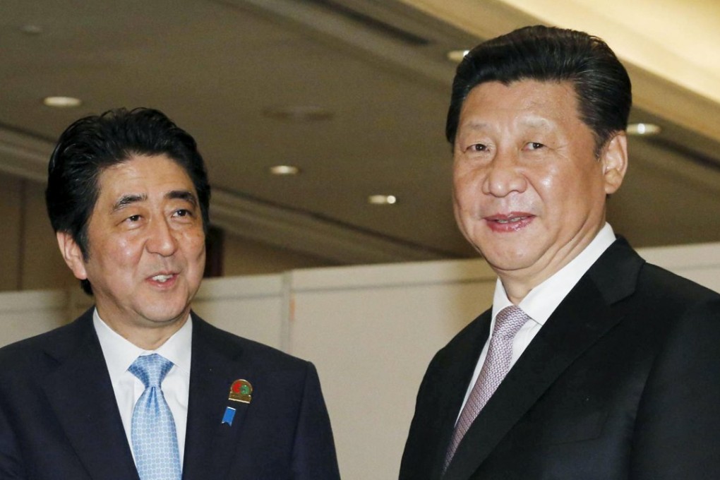 Japan's Prime Minister Shinzo Abe (left) and China's President Xi Jinping agreed to accelerate the process of improving relations between the two nations. Photo: Reuters