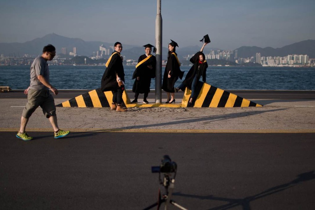 University students in Hong Kong pose for graduation photographs. Many young people today expect to have an egalitarian marriage. Photo: AFP