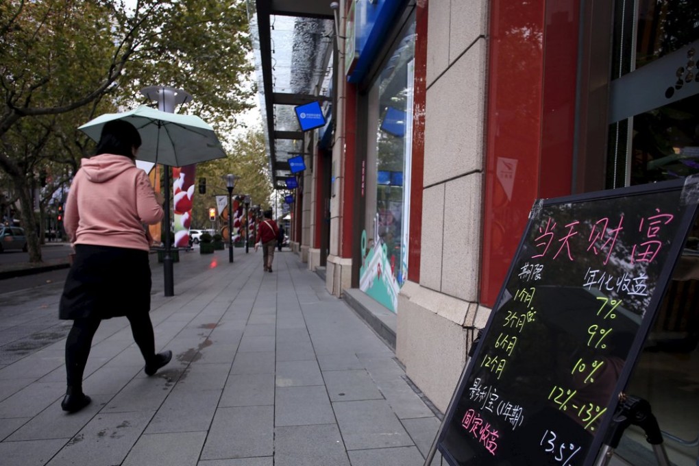A woman walks past a board showing the length and annual yield rates of finance products, outside a shop in ShanghaiOn November 18. A year after China's financial regulators squared up to the systemic perils of "shadow banking", the threat is shifting to a booming corporate bond market, and risky borrowers' debt is finding its way into products aimed at retail investors. Photo: Reuters