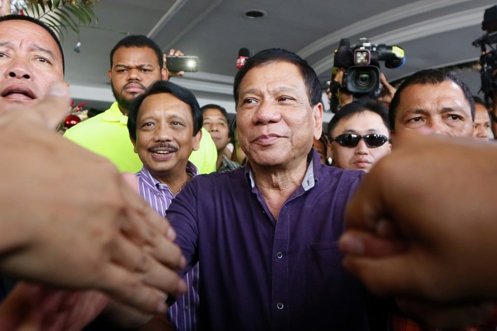 Mayor Rodrigo Duterte of Davao city in southern Philippines greets supporters last week prior to addressing the crowd about his presidential bid. Photo: AP