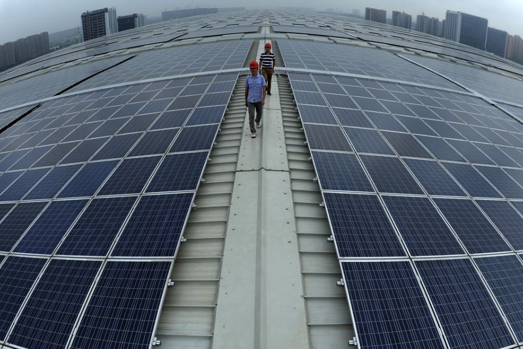 Two men walk on the roof of Hangzhou East Railway Station, which is covered by solar panels, in eastern China's Zhejiang province. Photo: AP