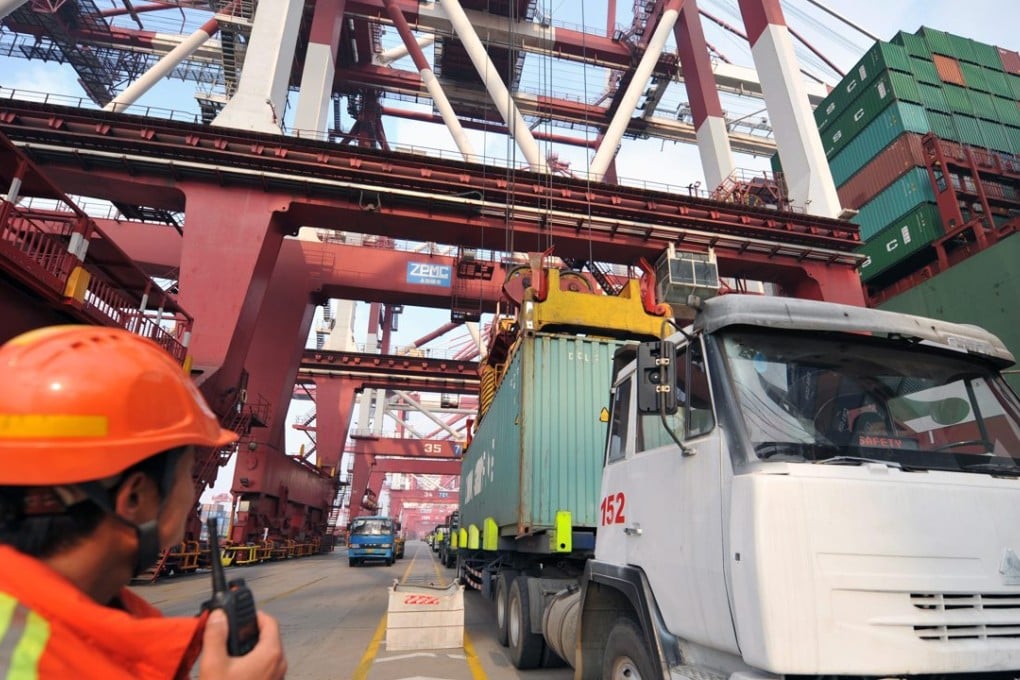 Trucks transport containers at the port of Qingdao, in eastern China's Shandong province. Photo: EPA