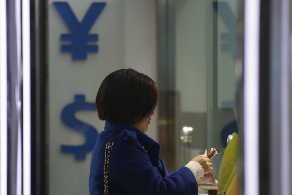 A woman counts yuan notes at a foreign exchange store in Shanghai. Photo: Reuters