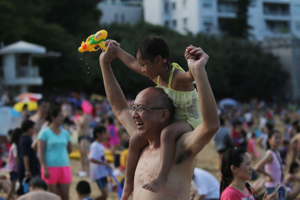 Swimmers relax on the Stanley Main Beach while Very Hot Weather Warning has been issued by the Hong Kong Observatory. 20JUN15