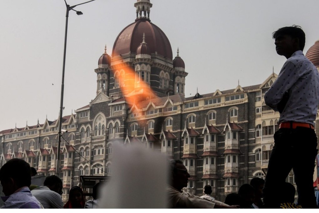 People light candles near the Taj Mahal hotel on the seventh anniversary of the Mumbai terror attacks last month. Photo: EPA