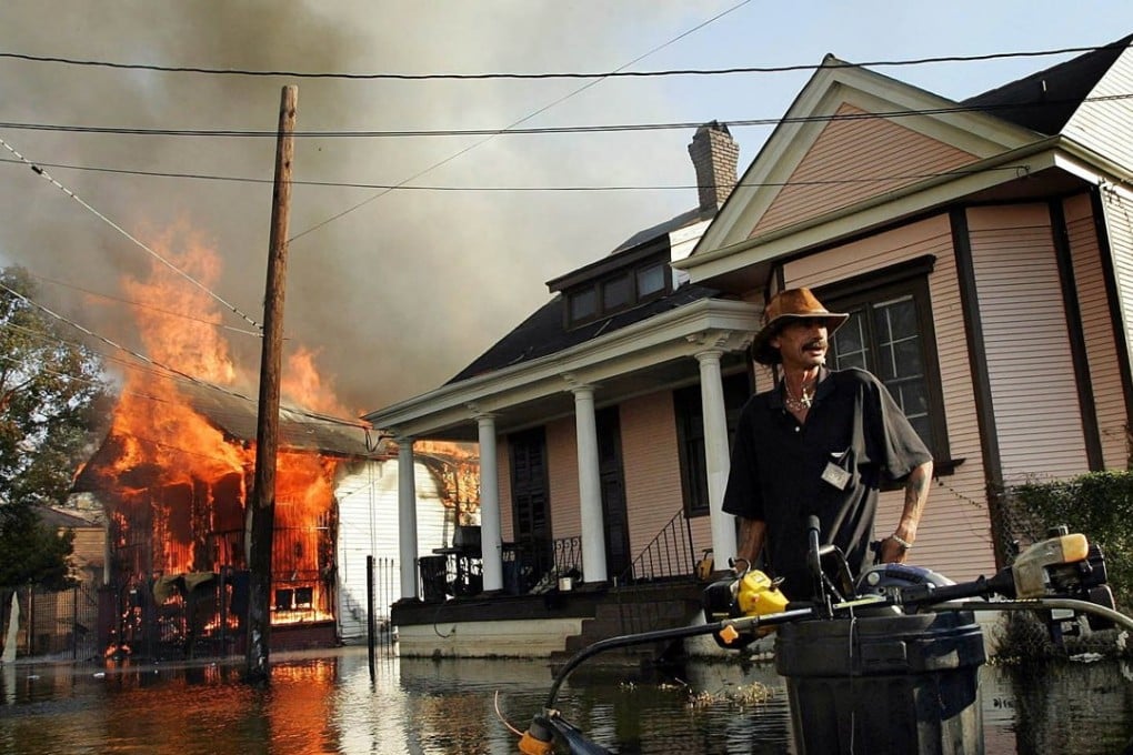A man endures fire and flood in the aftermath of Hurricane Katrina in 2005. Photo: Reuters