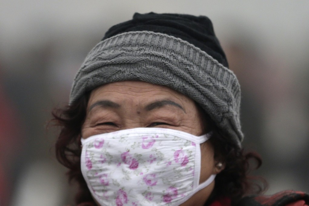 A file picture of a woman wearing a face mask during heavy smog in Beijing. The authorities fear some fake masks may have been sold overseas. There was no suggestion in the report that some were sold in China. Photo: AP