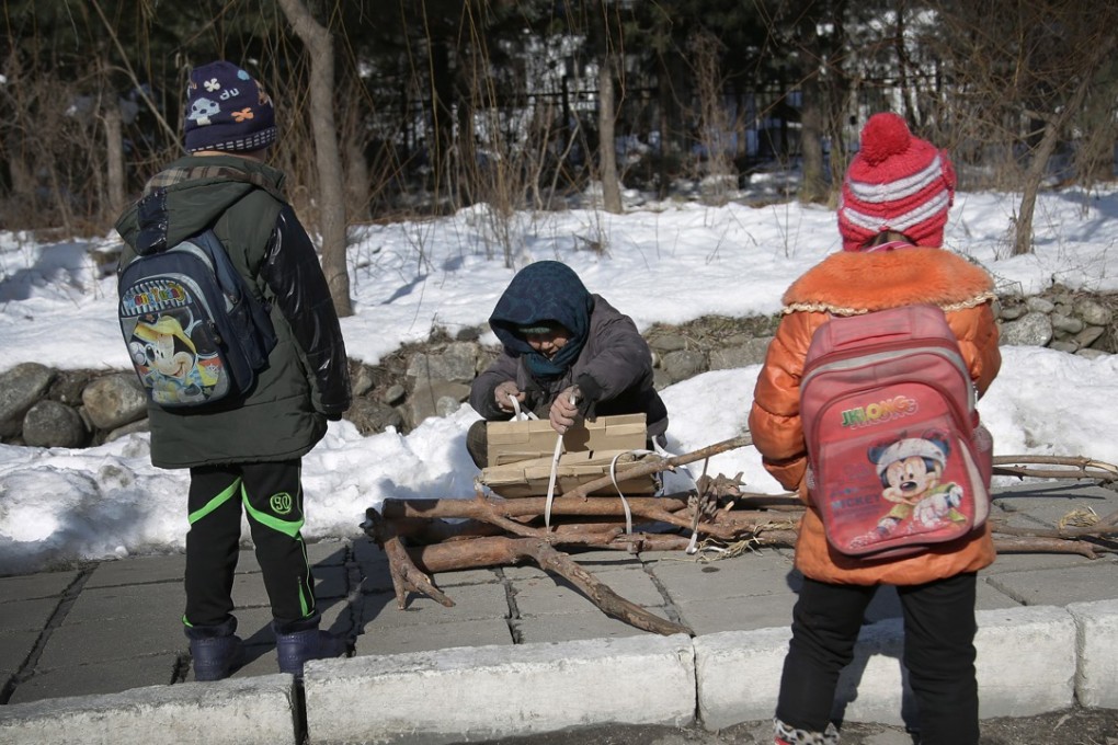 A file picture of North Korean children and their mother collecting wood. Rights groups say the offspring of North Koreans trafficked into China face hardship and discrimination. Photo: AFP