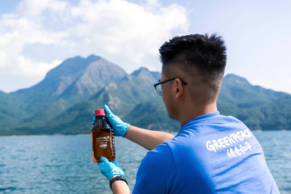 A Greenpeace volunteer takes a sample from one of the reservoirs. Photo: SCMP Pictures