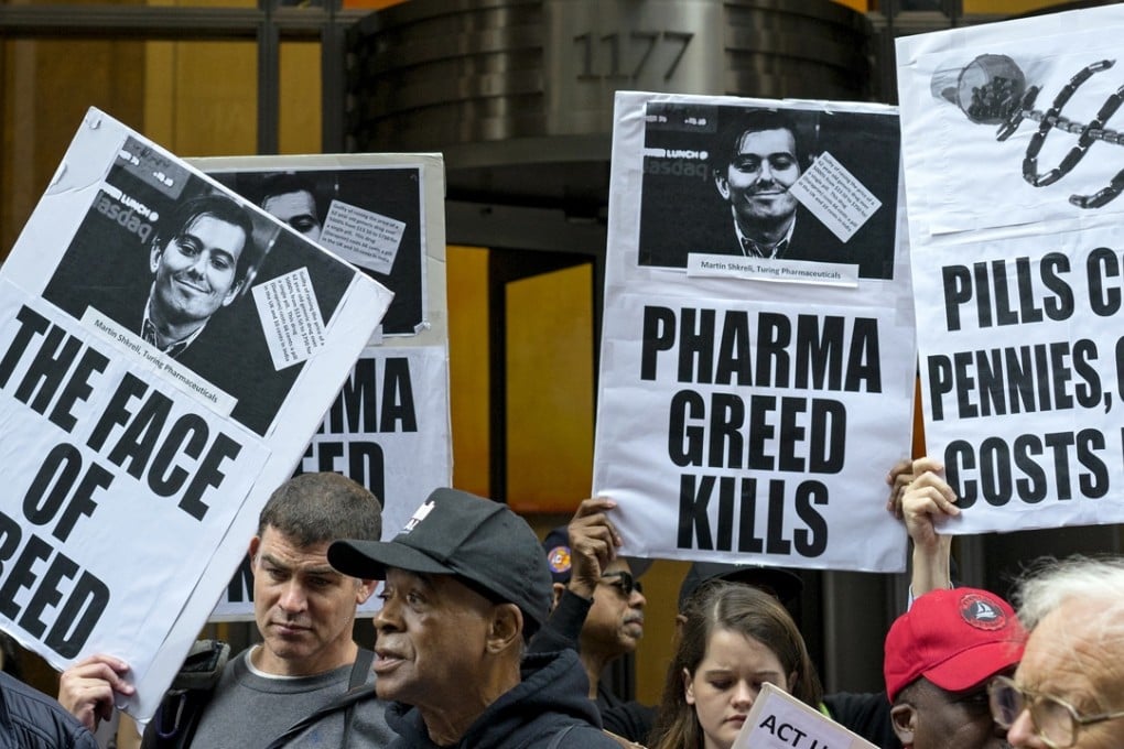 Activists hold signs bearing the image of Turing Pharmaceuticals CEO Martin Shkreli in front the building that houses Turing's offices in New York, during an October 1 protest highlighting pharmaceutical drug pricing. Photo: AP