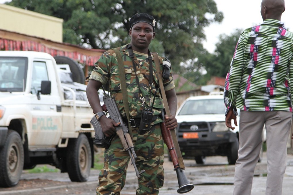 A Burundian soldier with his gun and rocket launcher guard a deserted street in Bujumbura, Burundi. Photo: AP