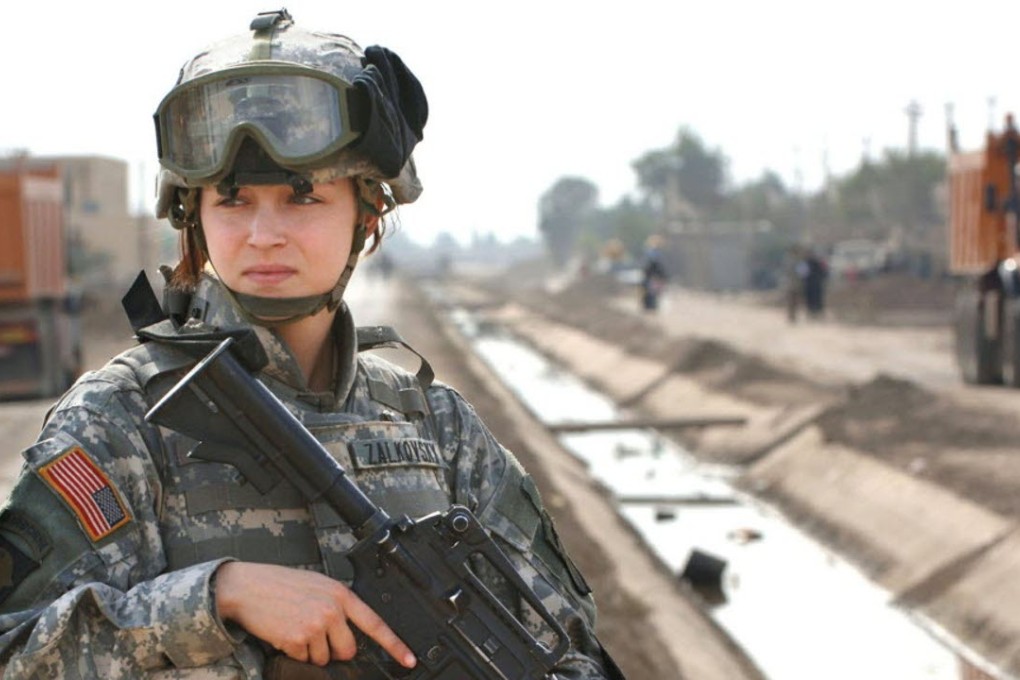 US soldier Private Janelle Zalkovsky, from civil affairs unit of 1st Battalion, 320th Field Artillery Regiment, 101st Airborne Division, provides security while other soldiers survey a newly constructed road in Ibriam Jaffes, Iraq in this 2005 photo. Photo: Reuters