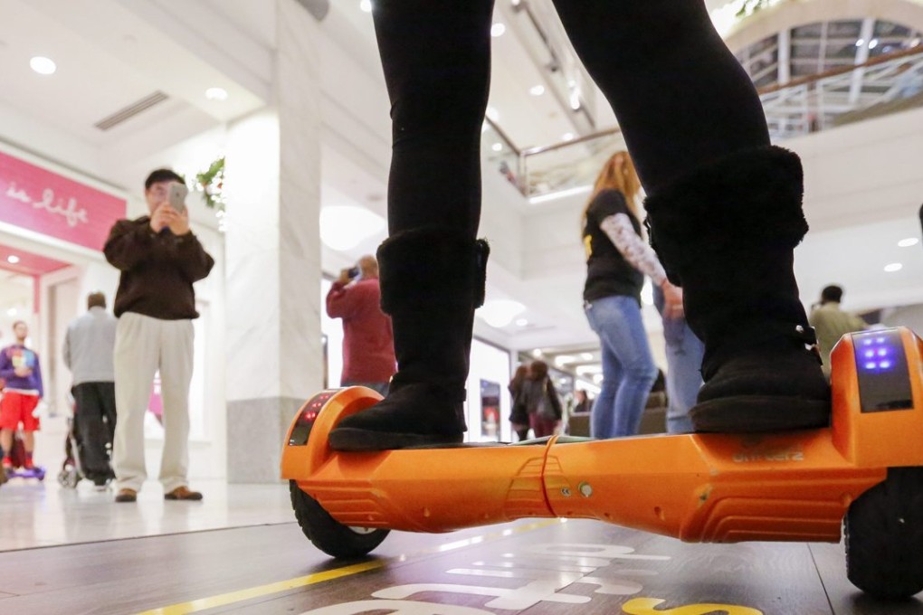 Shoppers view a sales person on a hover board at the Lenox Square Mall in Atlanta, Georgia. Photo: EPA