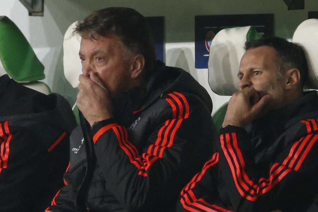 Louis van Gaal and assistant manager Ryan Giggs look dejected against Wolfsburg. Photo: Reuters