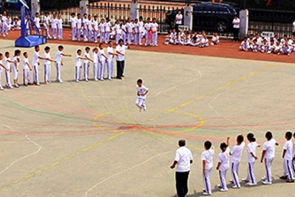 Pupils and teachers conduct physical education classes at the Tsinghua Univerity primary school. Photo: Thepaper.cn