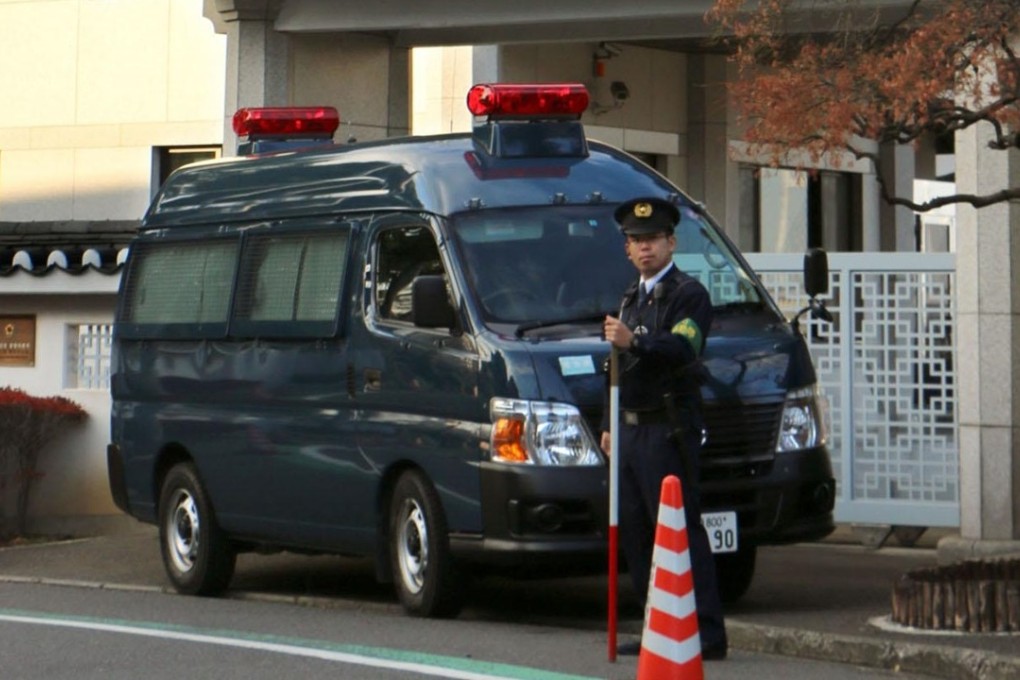A Japanese police officer guards South Korea’s consulate in Yokohama after someone tossed a box full of excrement into the compound. Photo: Kyodo