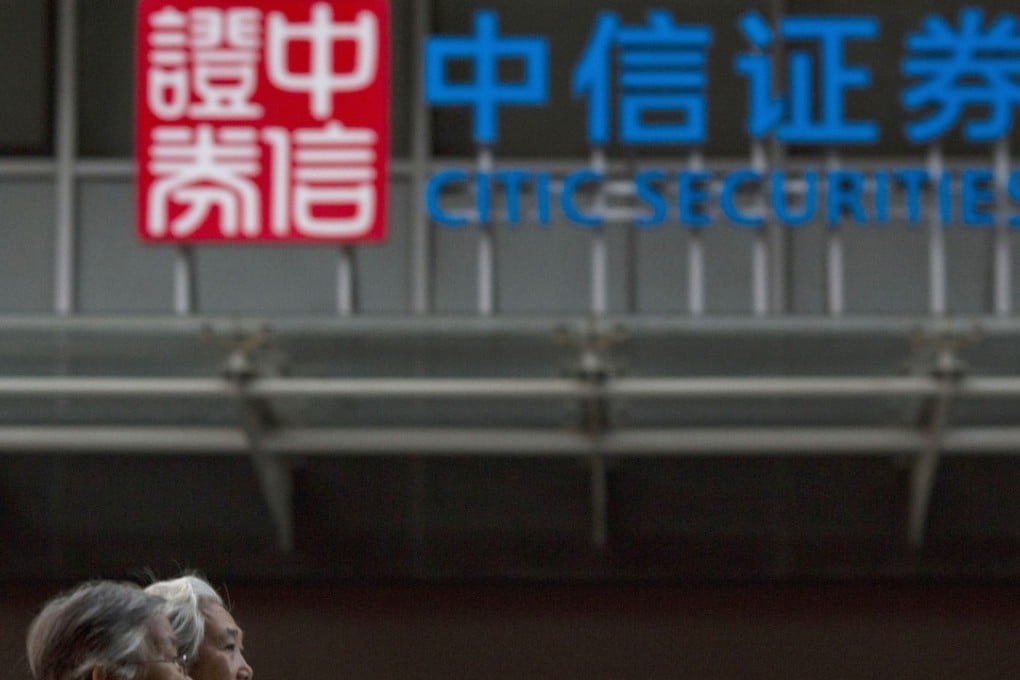 An elderly Chinese women walk near the logo for Citic Securities in Beijing. The company has been downgraded by S&P. Photo: AP