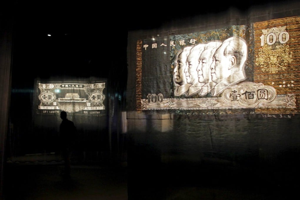 A file phone depicting crafted embroidery works based on old Chinese Yuan (Renminbi) bank notes. Photo: Reuters