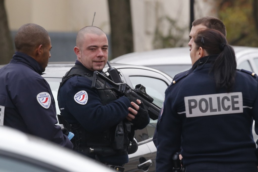 Police officers patrol near a pre-school, after claims that a masked assailant who mentioned the Islamic State group attacked a teacher on Monday. Authorities now say the teacher made the story up. Photo: AP