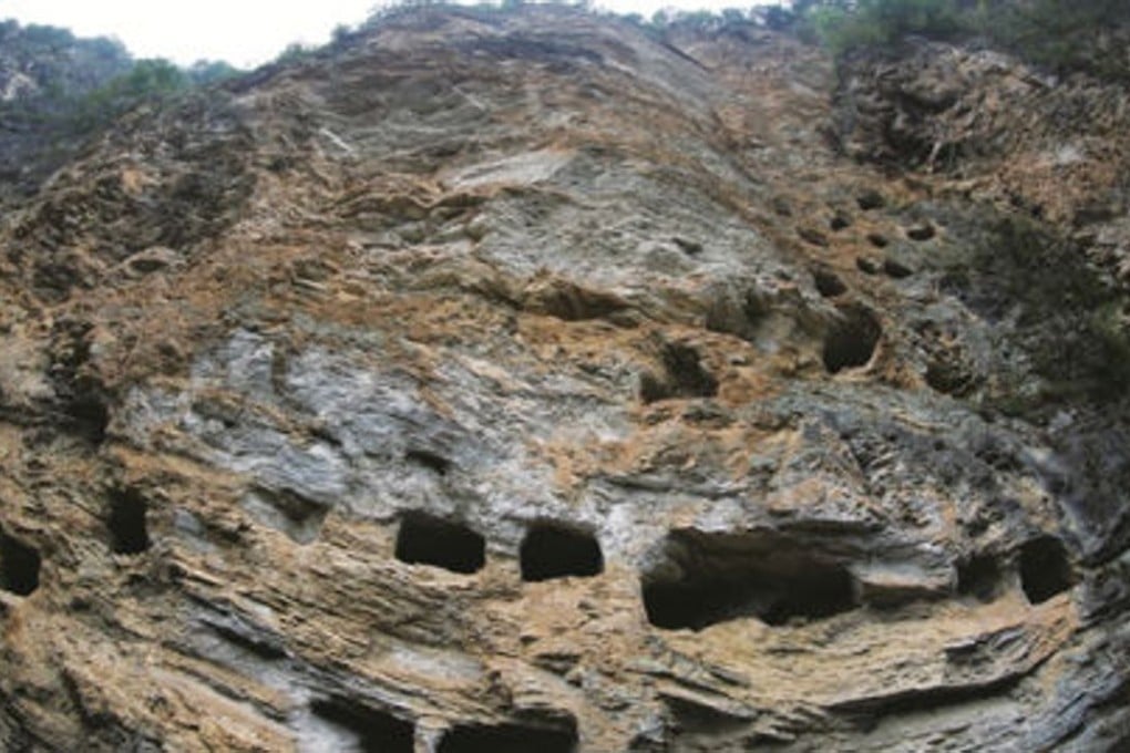 The ancient coffins were placed in holes, carved into an area covering more than 50 metres, on the side of a 100-metre-high cliff, beside a river near the Three Gorges Dam in China’s Hubei province. Photo: Three Gorges Business News