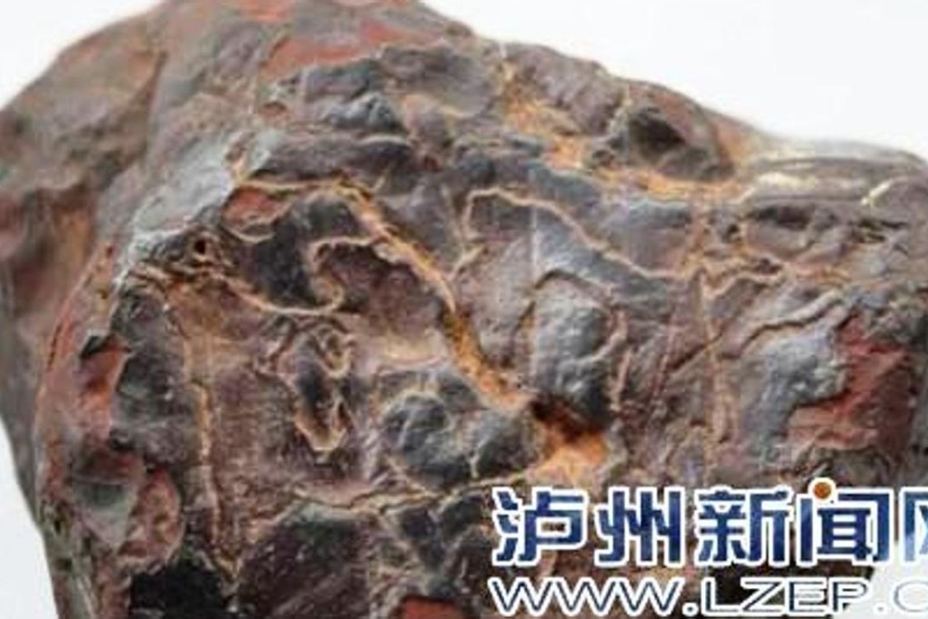 The meteorite, found in southwest China, weighs about 700 grams. Chinese law is vague about who actually owns rocks from space. Photo: Lzep.cn