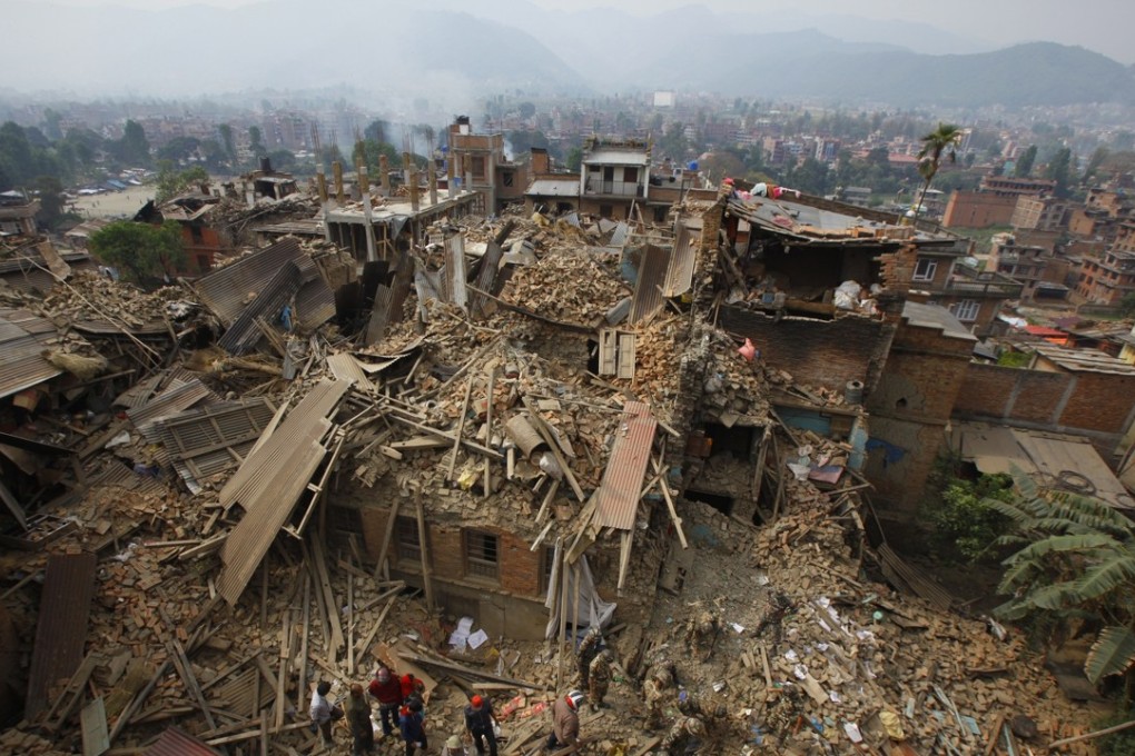 Rescue workers remove debris as they search for victims of the earthquake in April in Bhaktapur near Kathmandu, Nepal. Photo AP