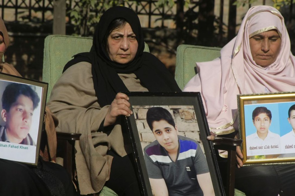 Pakistani mothers hold pictures of their children killed in the Taliban attack. Photo: AP