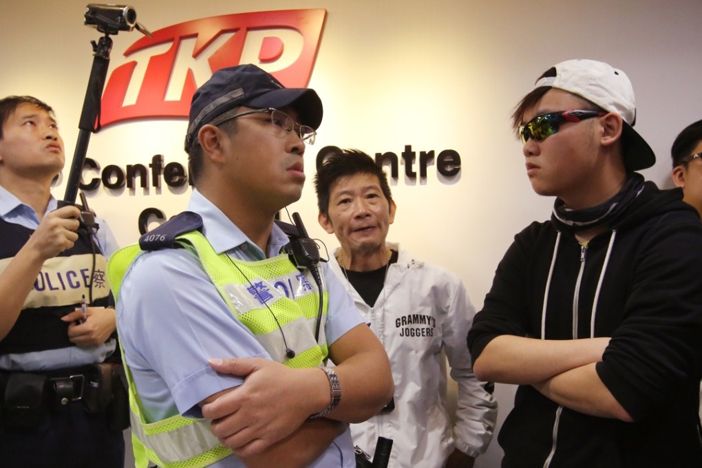 Police officers stand guard after members of Civic Passion stormed last week’s meeting of the Hong Kong Copyright Alliance. Photo: Edward Wong