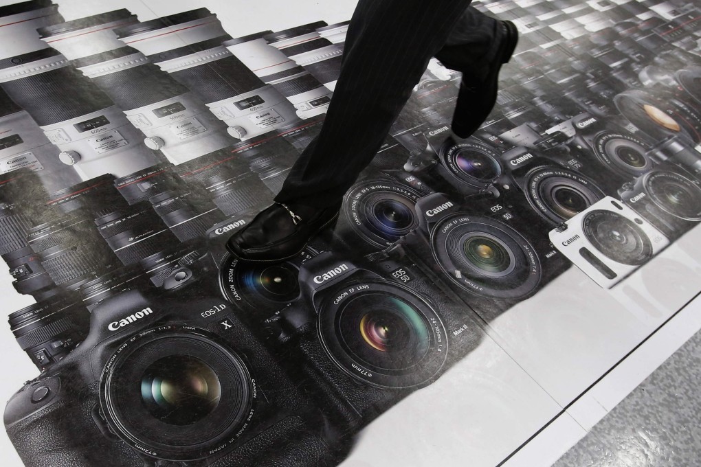An advertisement of Canon digital cameras and lenses. Photo: Reuters