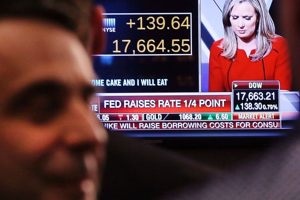Traders on the floor of the New York Stock Exchange (NYSE) chat with each other as the US Federal Reserve announces an increase in US interest rates for the first time in almost a decade. Photo: AFP
