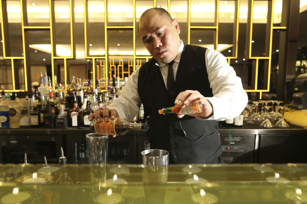 Aarlon Caparas, Aqua’s bar manager makes a Bloody Tokyo. Photo: Dickson Lee
