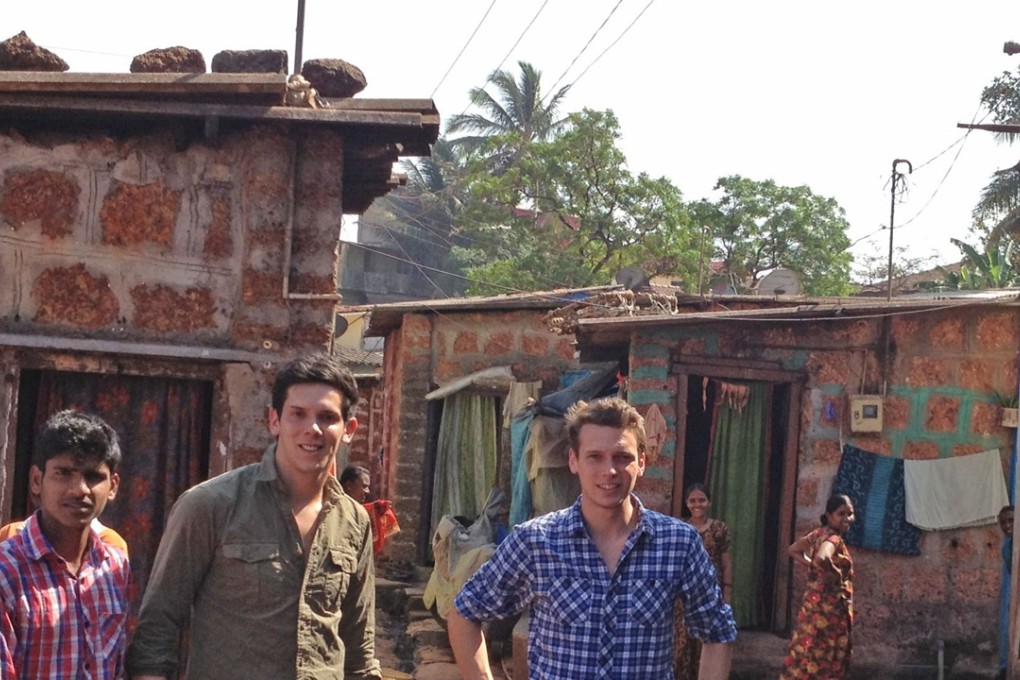 Rob (left) and Paul Forkan visiting orphans in India. Photo: AFP
