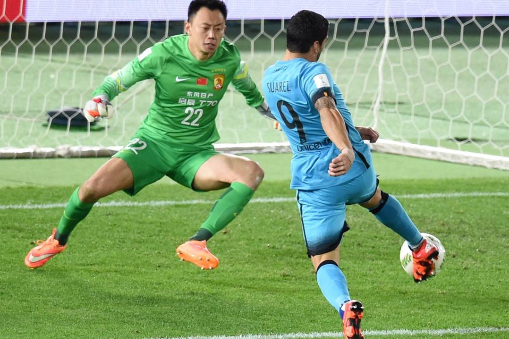 Barcelona’s Luis Suarez lashes the opener past Guangzhou Evergrande goalkeeper Li Shuai during their Club World Cup semi-final in Yokohama. Barcelona romped to a 3-0 victory with Suarez notching a hat-trick. Photo: AFP